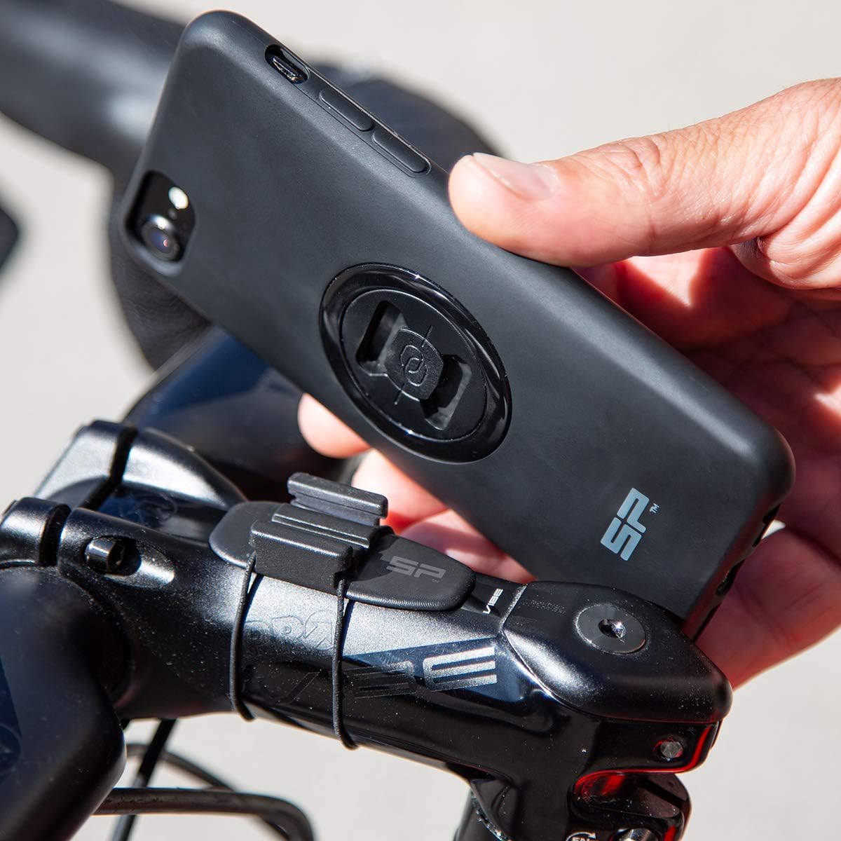 Hand attaching a smartphone with an SP CONNECT case to the Aero Mount Pro.