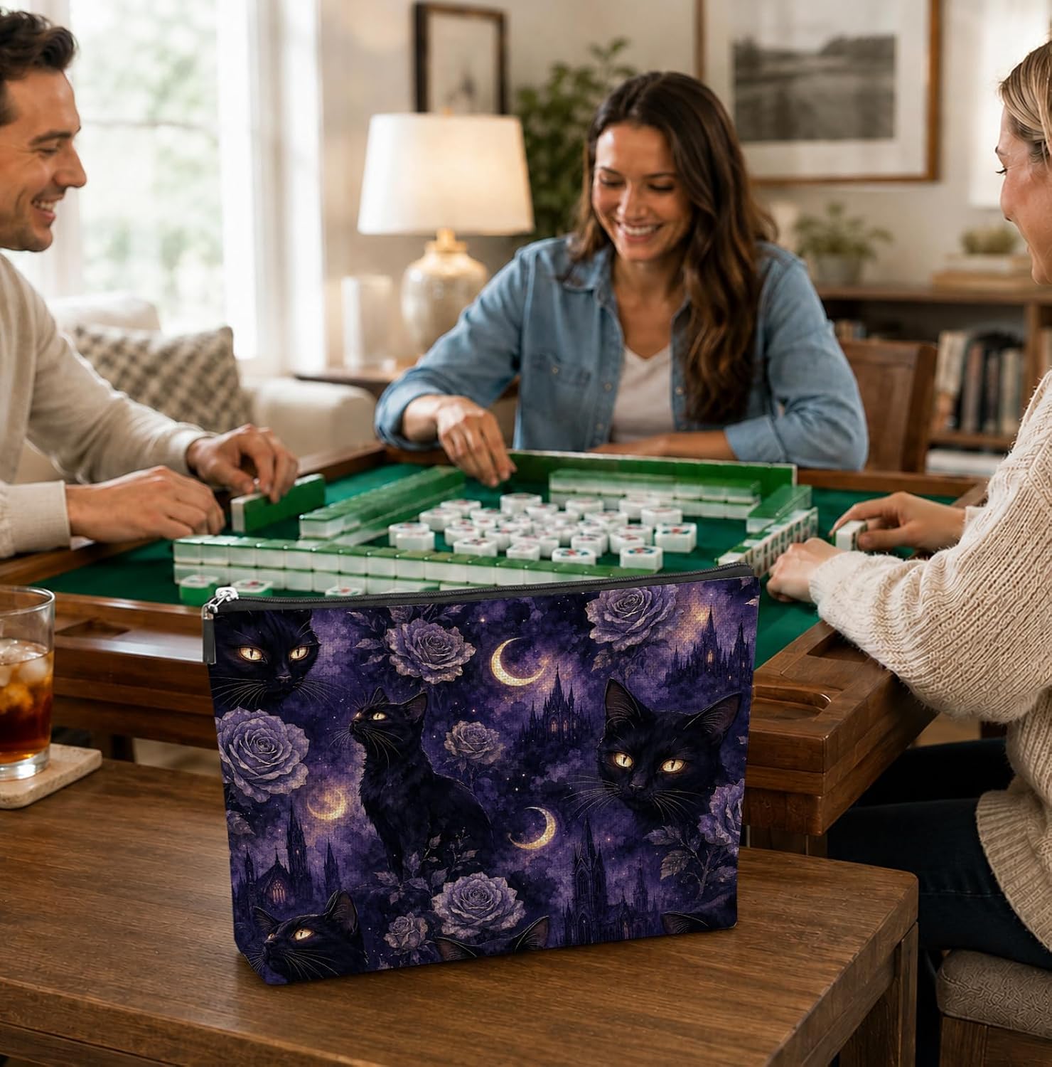 Friends playing Mahjong with the Halloween Mahjong Tile Bag - Black Cats & Moons on the table