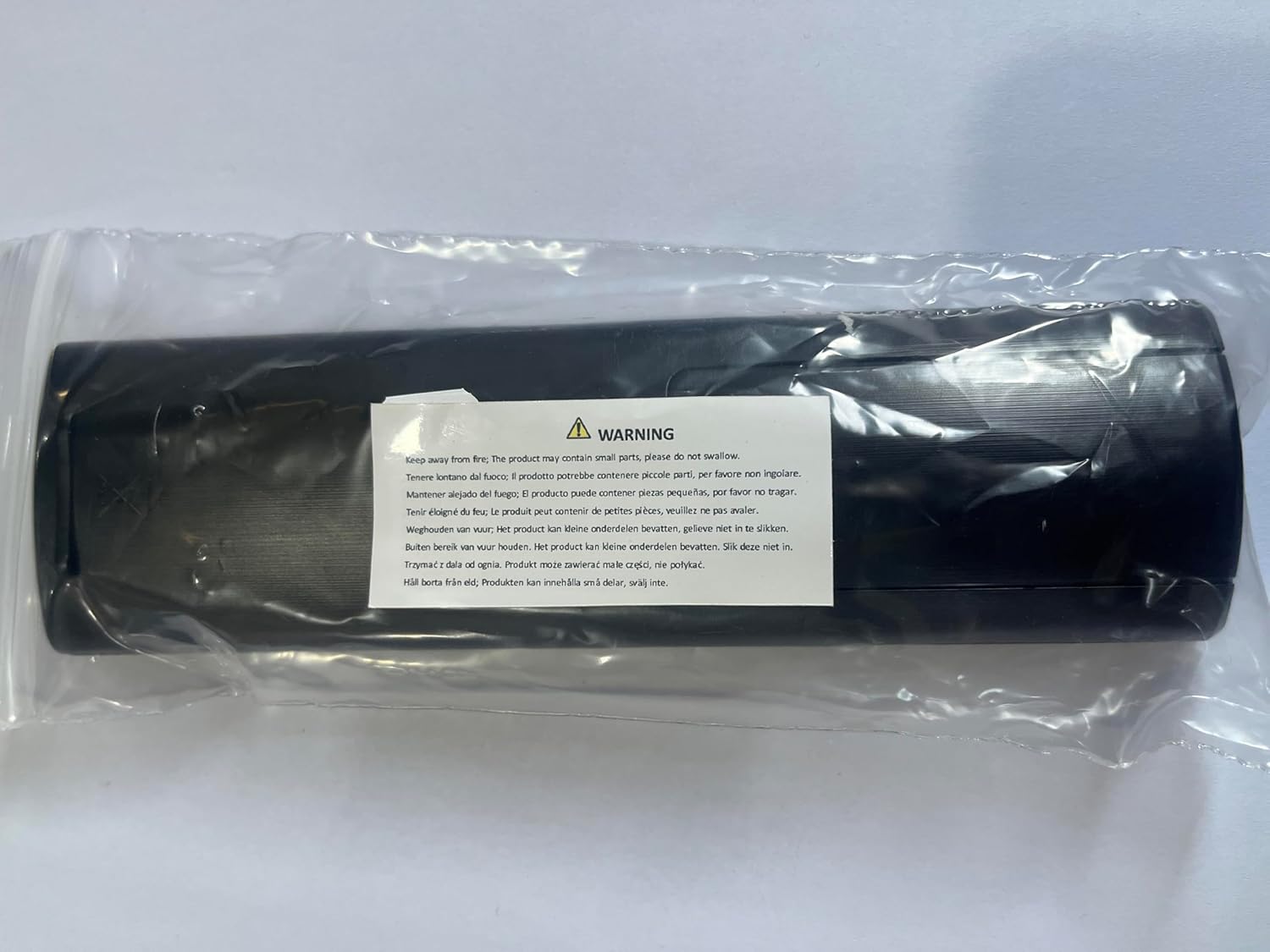 Warning label on product packaging indicating small parts and fire hazard.