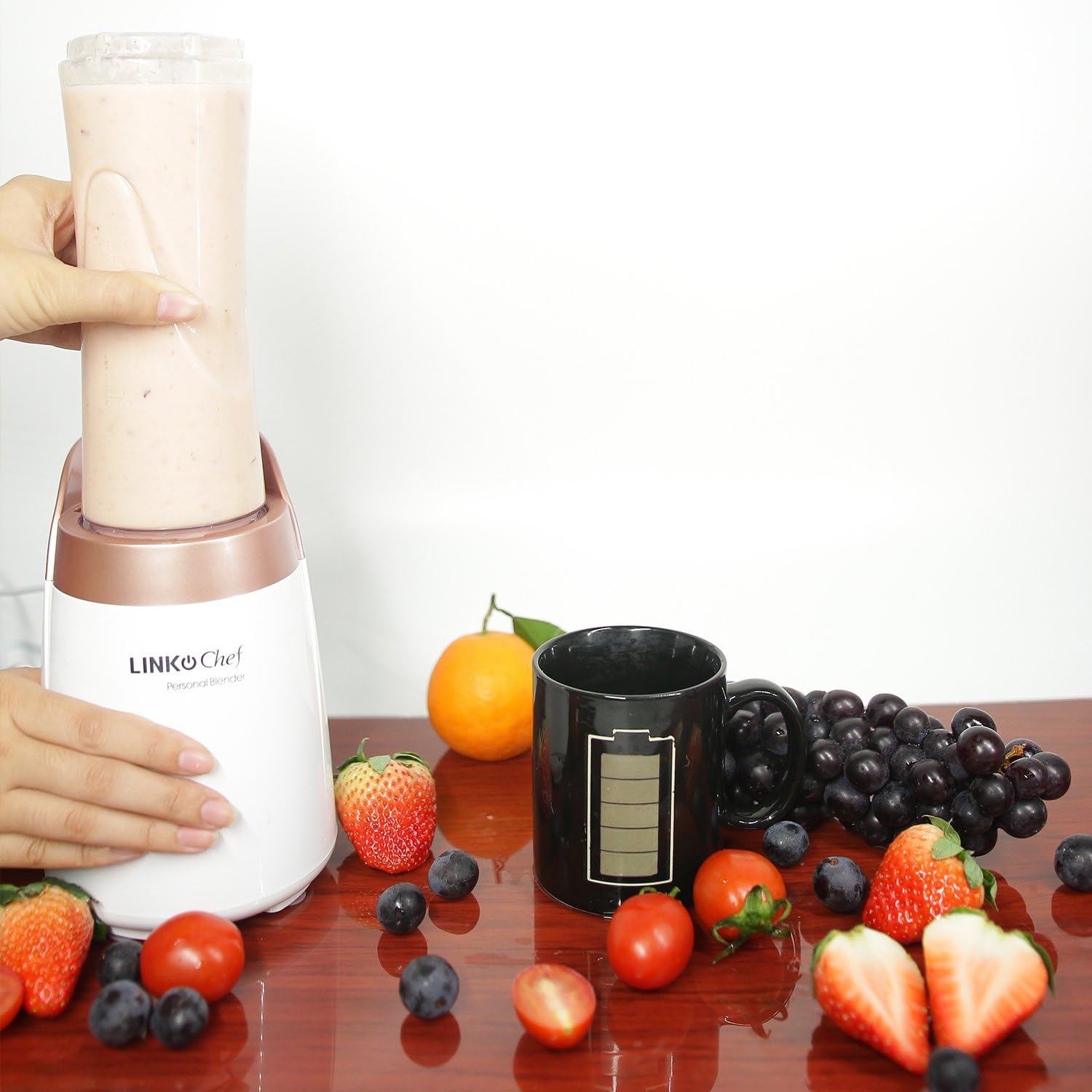 LINKChef blender in use, blending a smoothie with fresh fruits around it
