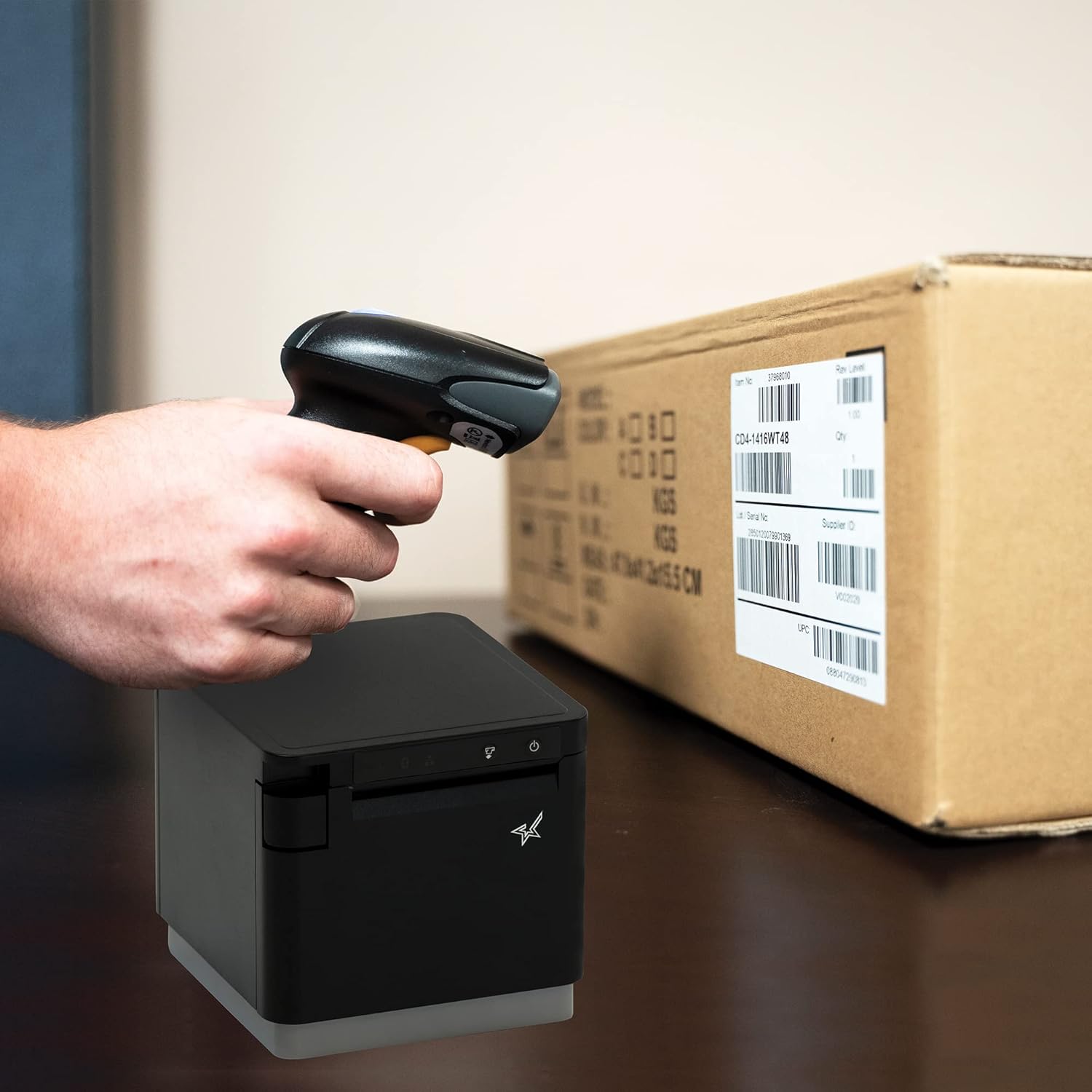 Person scanning a barcode on a package with the Star Micronics BSH-HR2081BT Barcode Scanner
