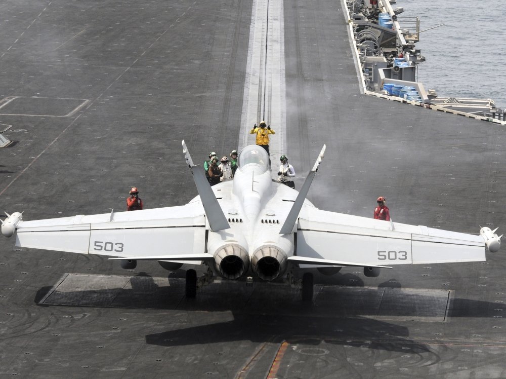 Sailors perform pre-launch checks on an EA-18G Growler Poster Print (32 x 24)