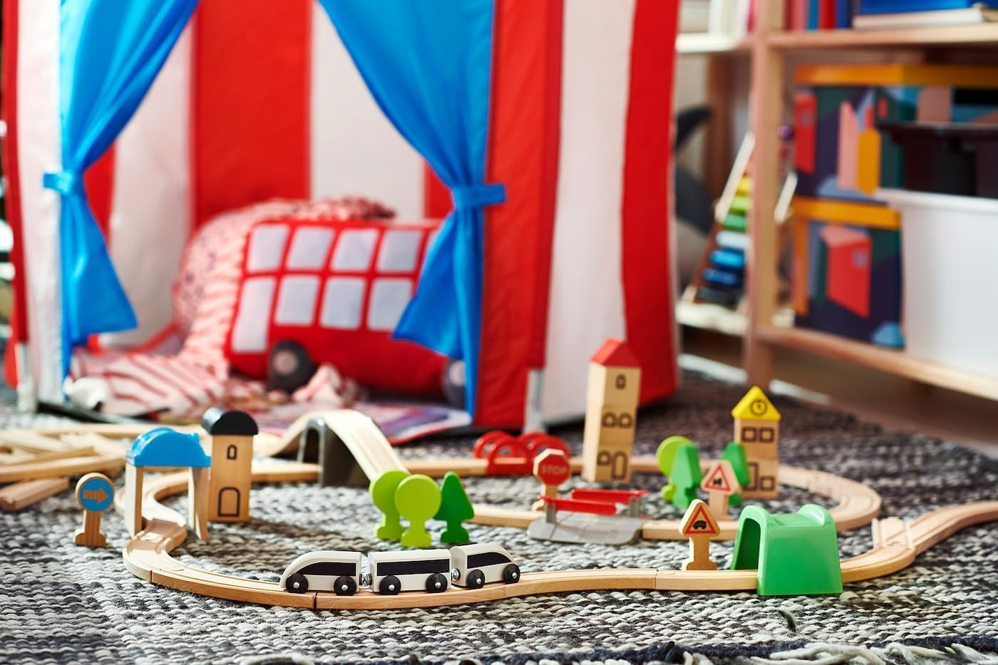 An assembled IKEA LILLABO train set layout with a train, tunnel, bridge, and various landscape accessories