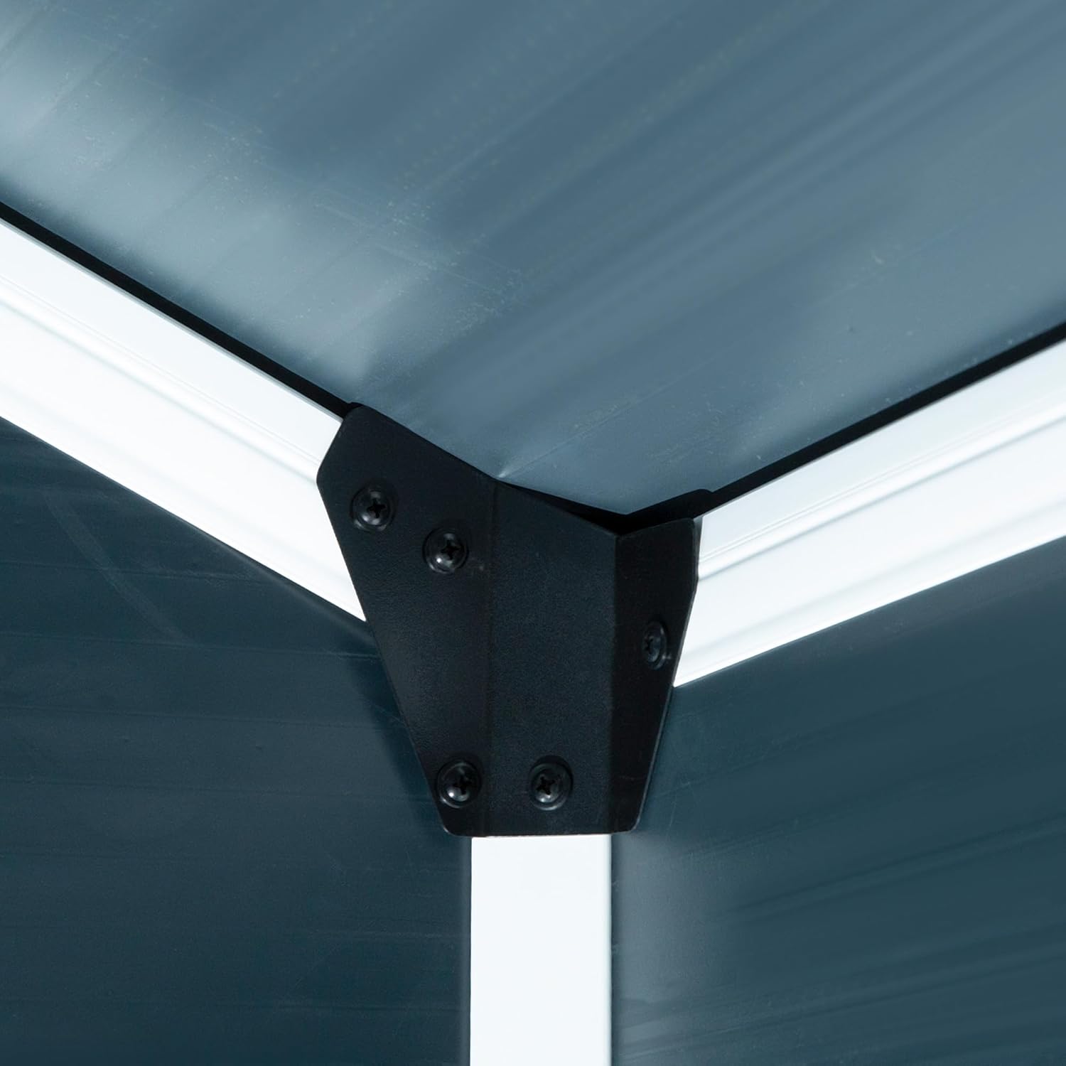 Close-up of an interior corner joint of the shed, showing the black bracket and grey panels.