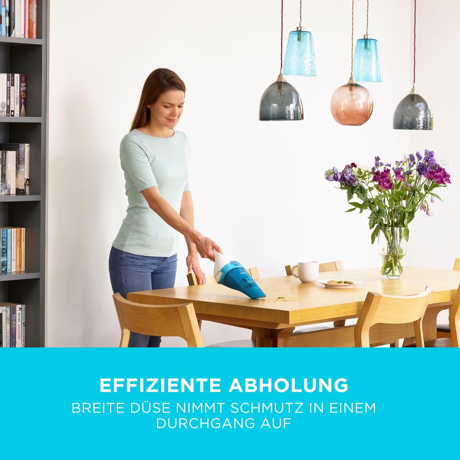 Hand holding BLACK+DECKER WDC115WA-QW vacuum, showing transparent dust bowl