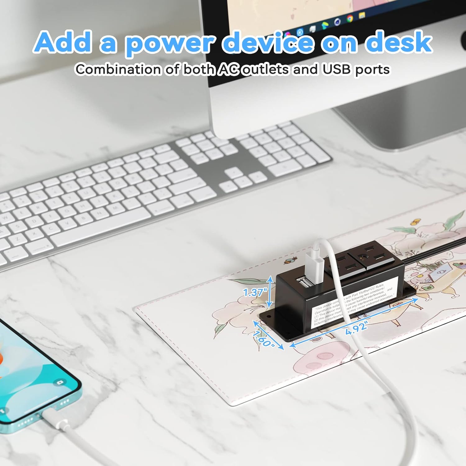 Power strip mounted on a desk surface, providing AC and USB power for a monitor and phone.