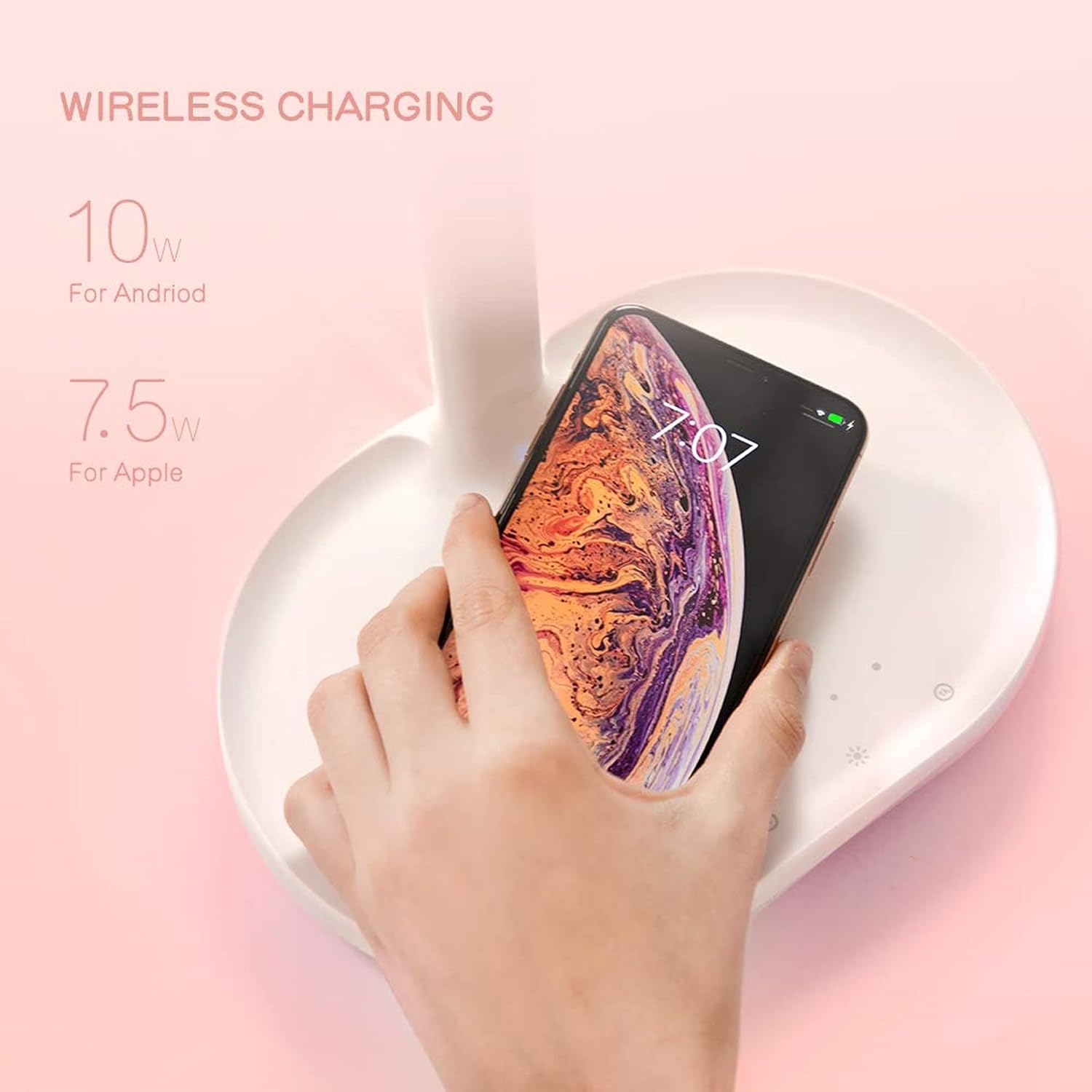Smartphone charging wirelessly on the base of the MOMAX Q.LED mirror