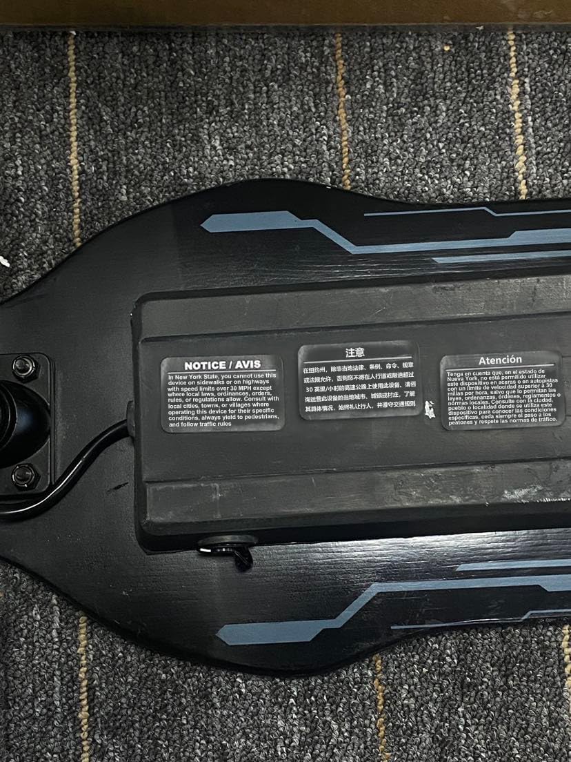 A close-up of the iScooter charger with a warning label to unplug when not in use.