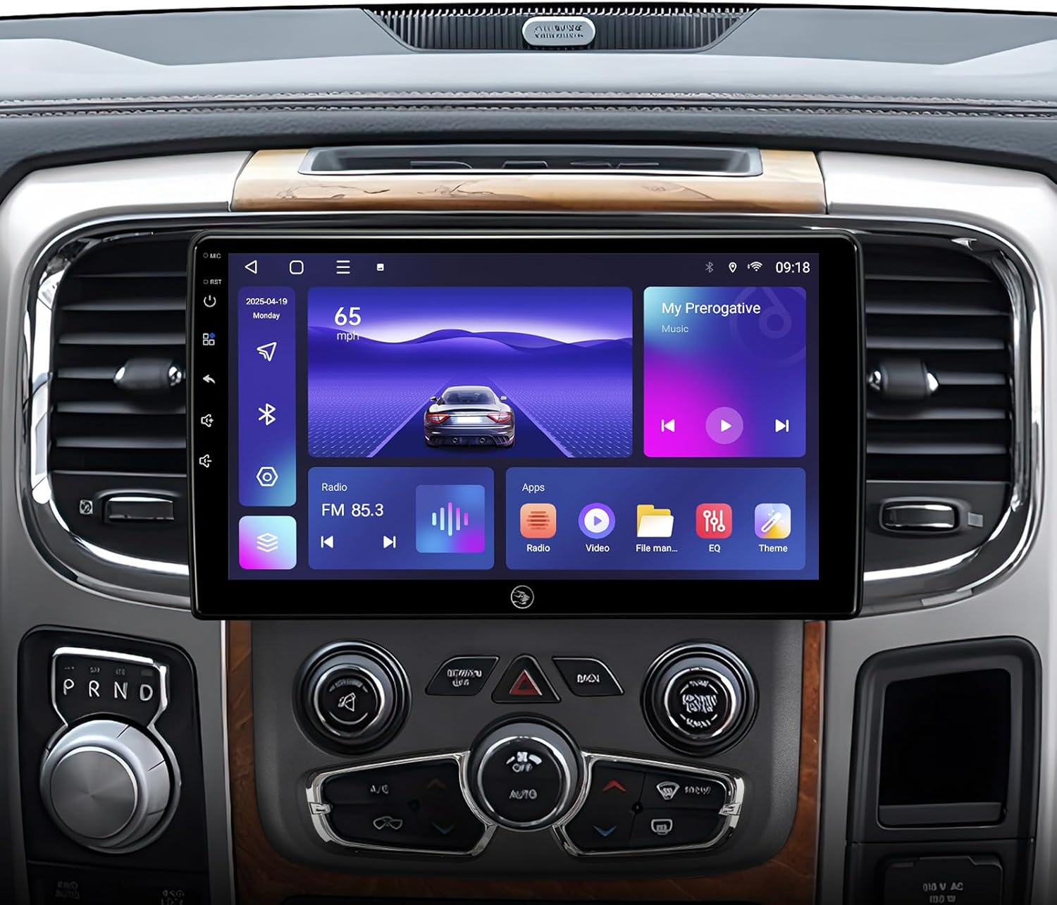 The AINAVI 10-inch car stereo installed in a Dodge Ram dashboard, displaying the main interface with navigation, music, and app icons.