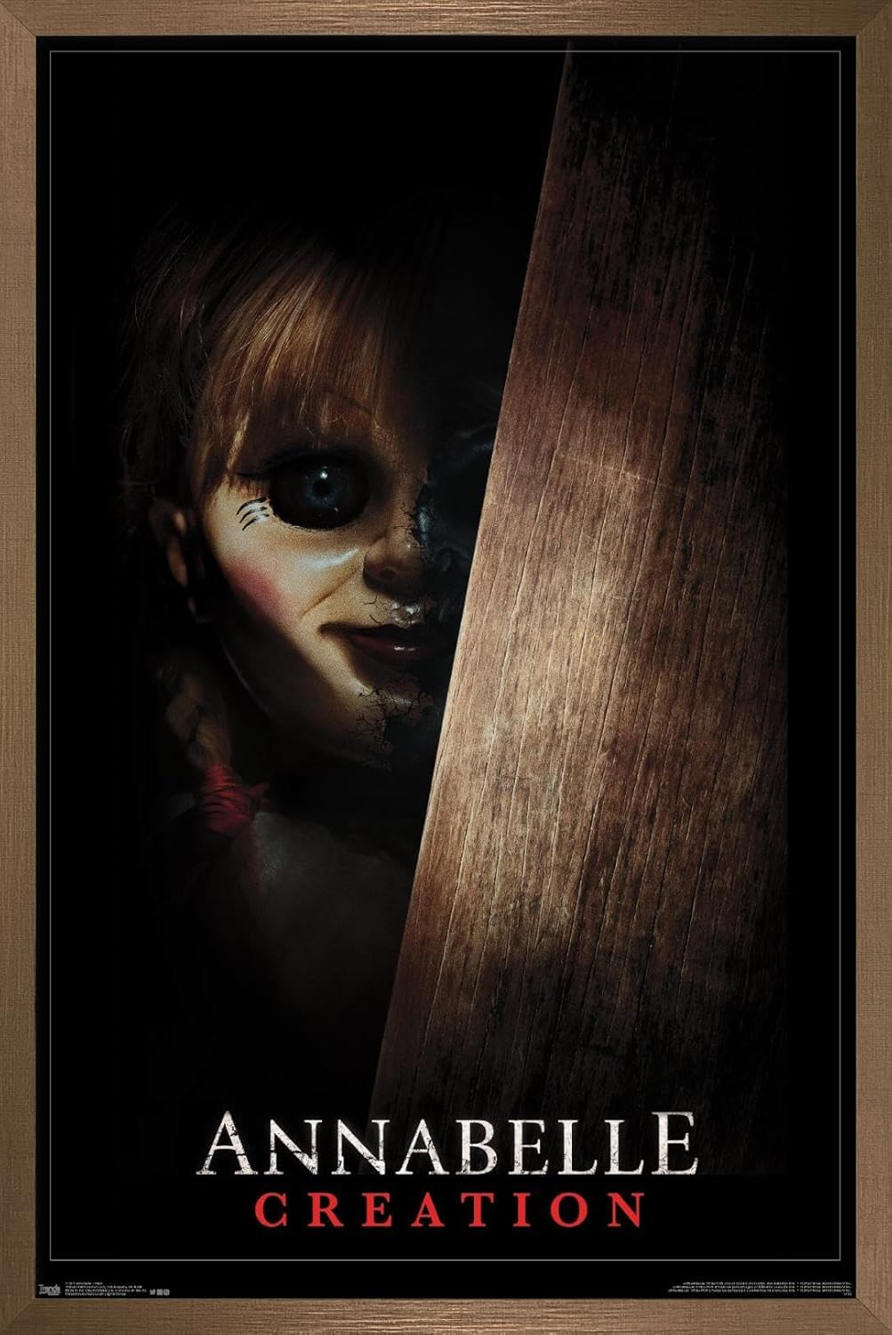 Trends International Annabelle - Peek Wall Poster, 22.375" x 34", Print and Black Hanger Bundle