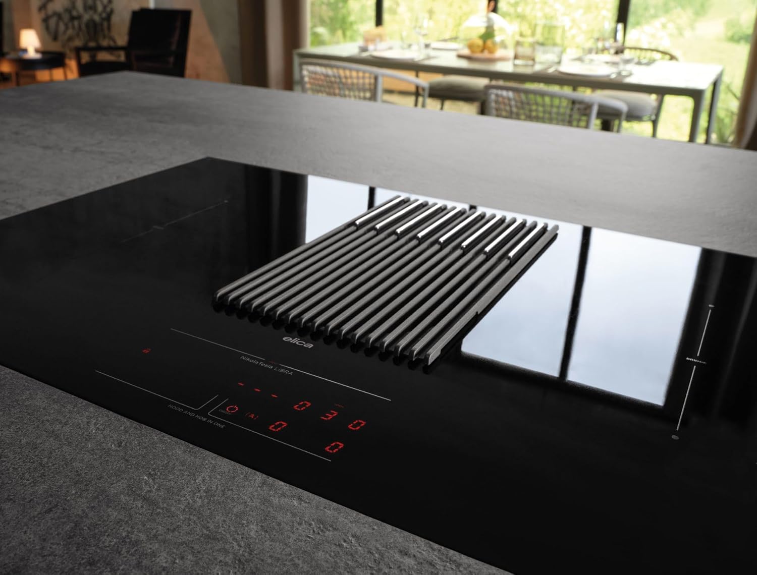 Close-up view of the Elica NikolaTesla Libra induction hob's control panel, showing the integrated hood's grilles and digital displays.