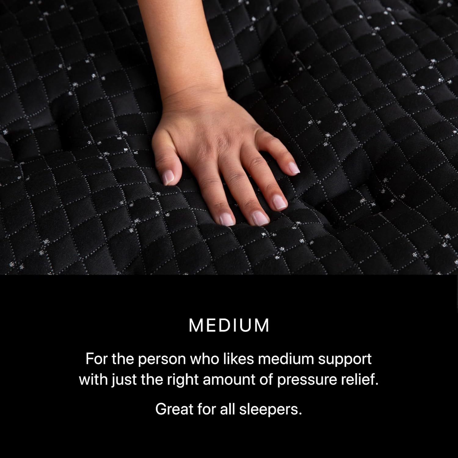Hand pressing on the surface of the Beautyrest Black Series Three Medium mattress