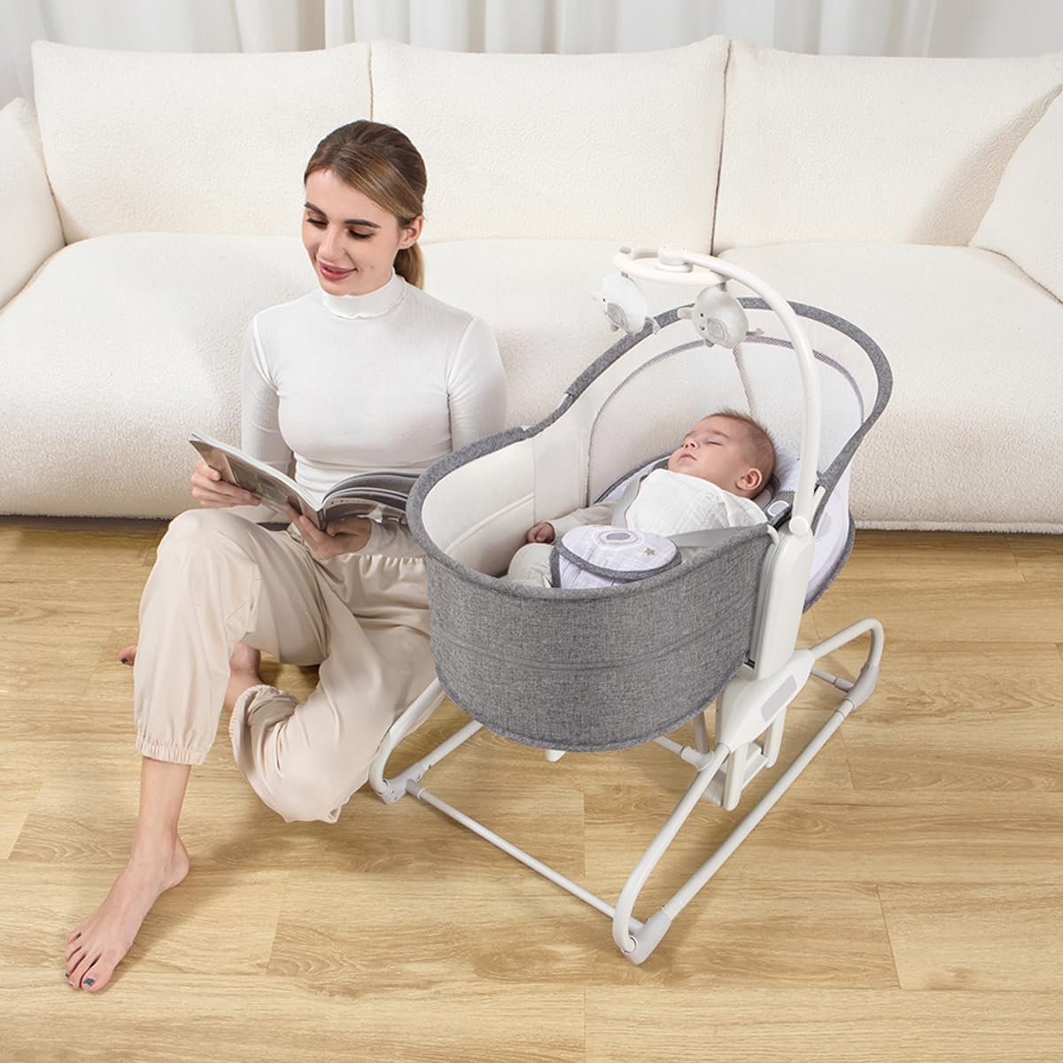 Baby sleeping in Mastela 4-in-1 Bassinet Chair with mobile and mosquito net