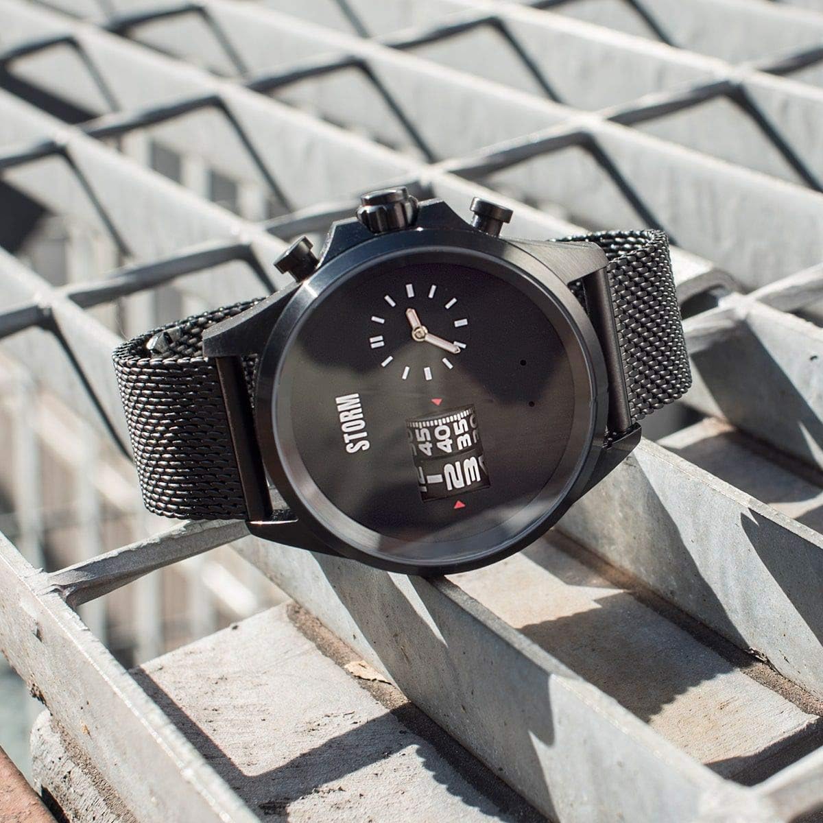STORM KOMBITRON Slate watch resting on a metal grate