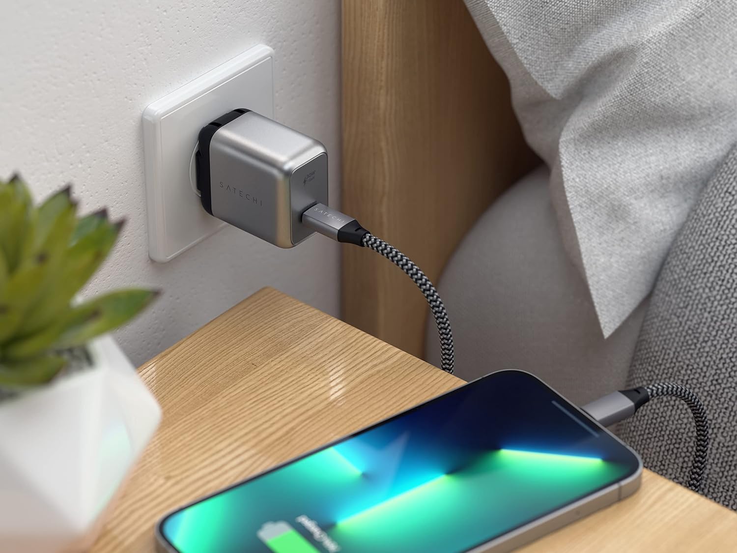 Satechi 30W USB C Charger Block charging an iPhone on a nightstand.