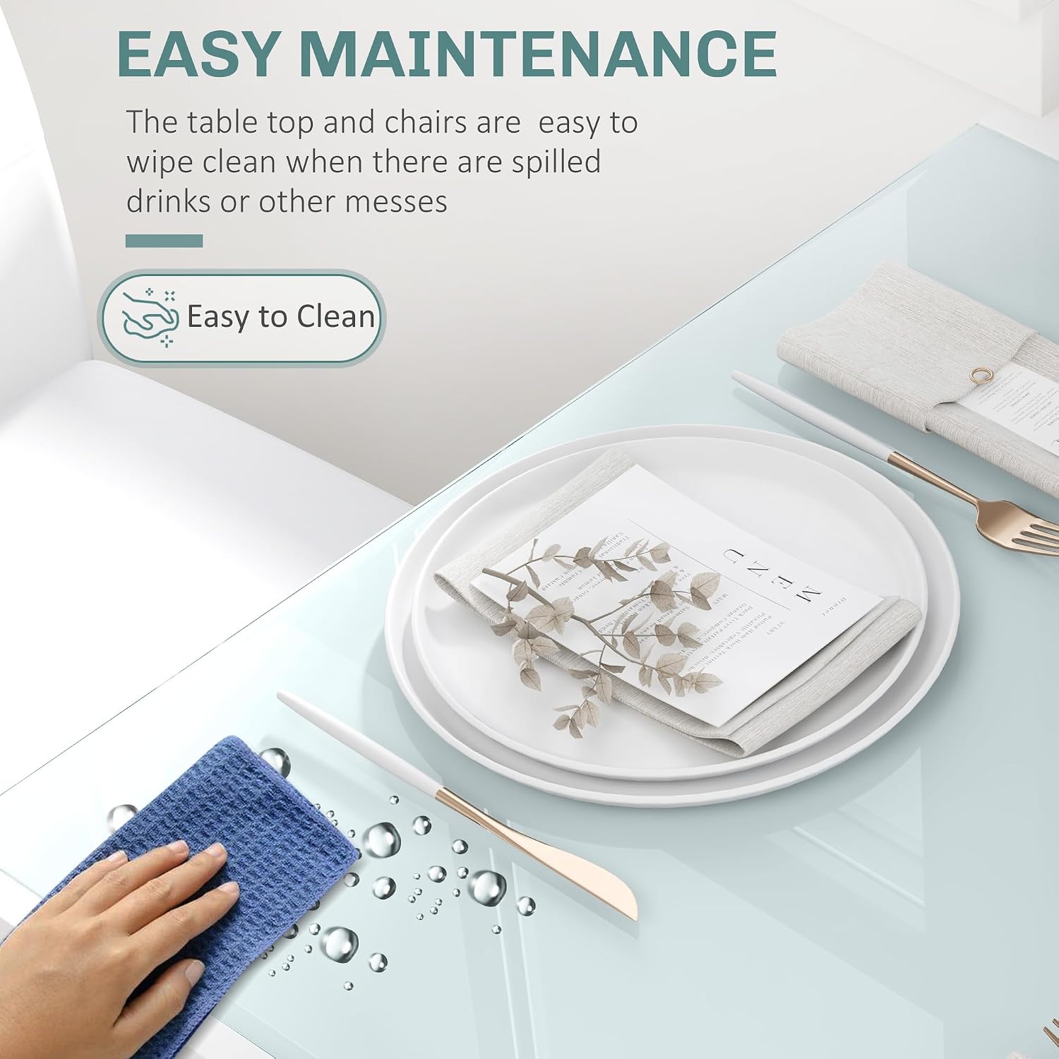 Hand wiping the glass table top with a blue cloth