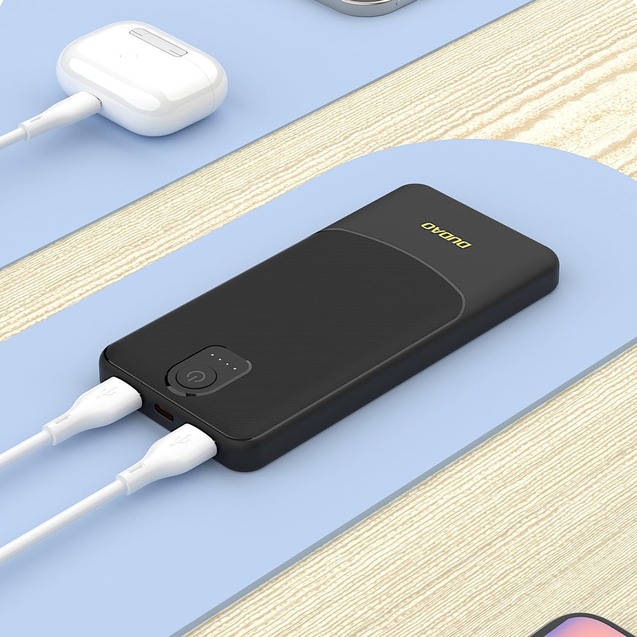 Black DUDAO K10 Power Bank charging two smartphones simultaneously.