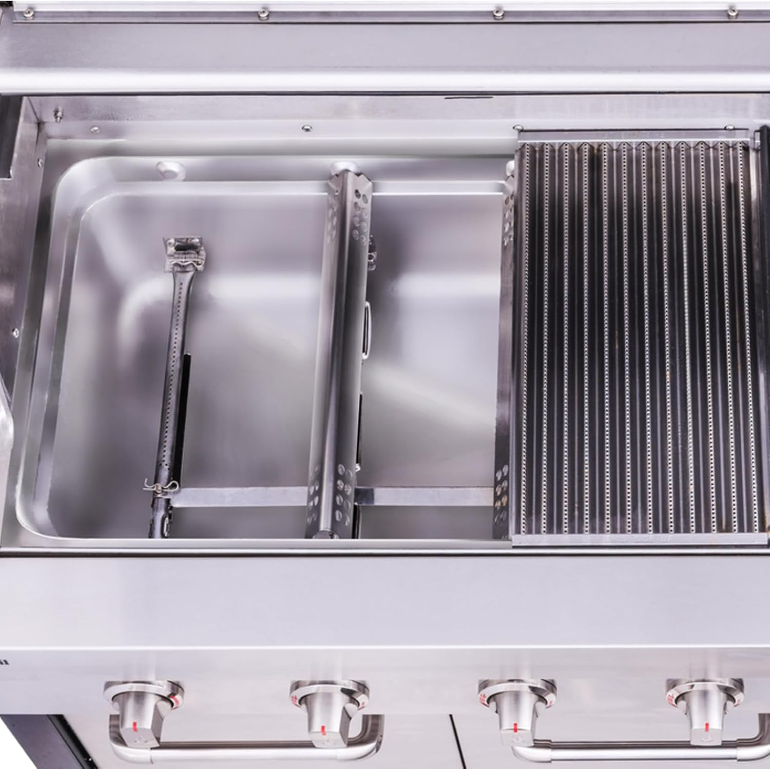 Top-down view of a grill interior with new heat plates and burners installed, ready for use.