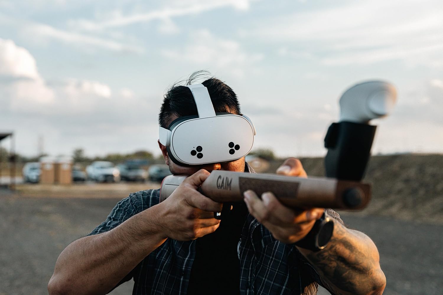 A person wearing a Meta Quest VR headset and holding the GAIM fixed laminate stock, aiming forward.
