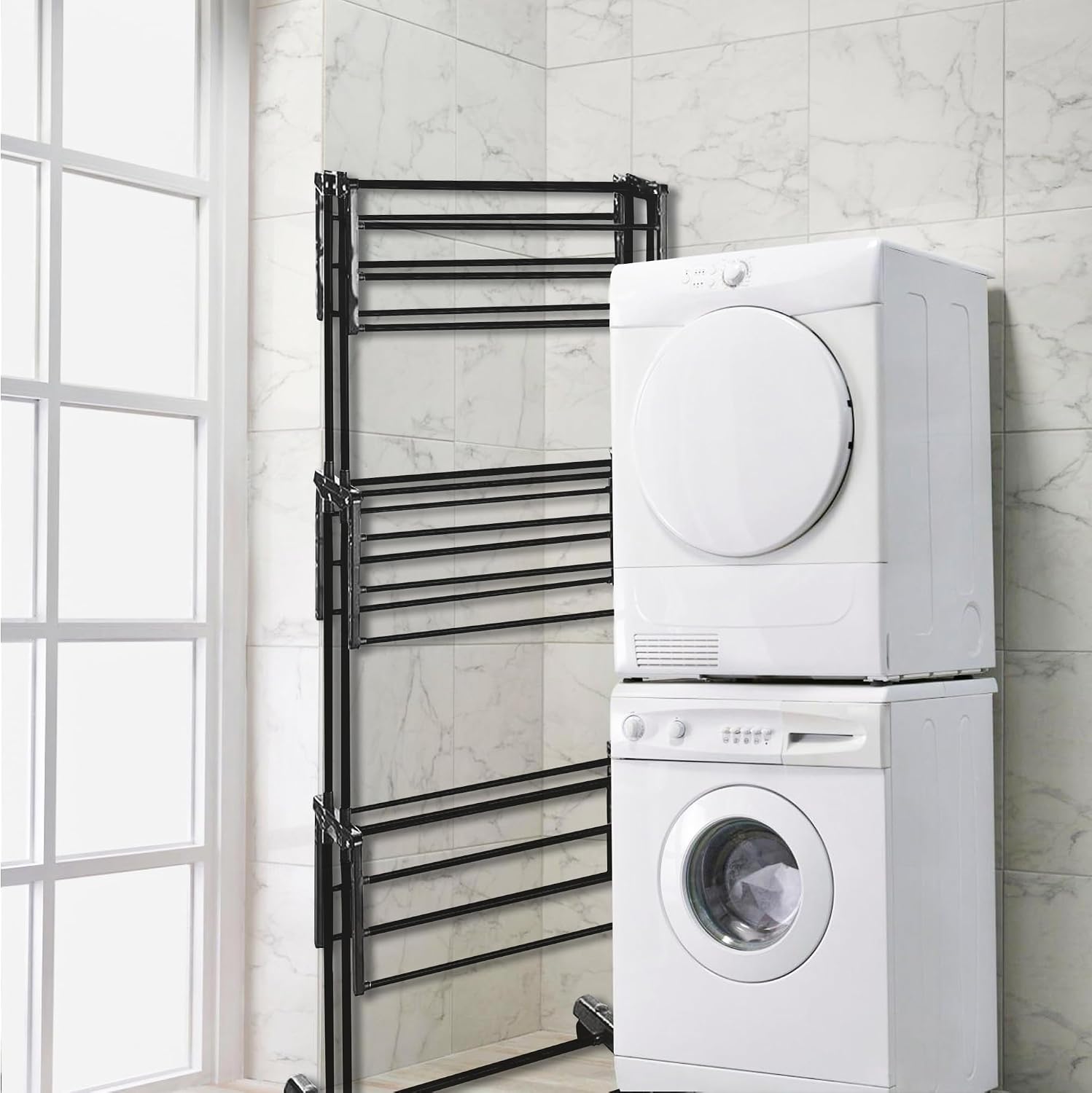 Vonia 3-tier drying rack folded compactly, standing upright next to a stacked washer and dryer, demonstrating its space-saving storage.