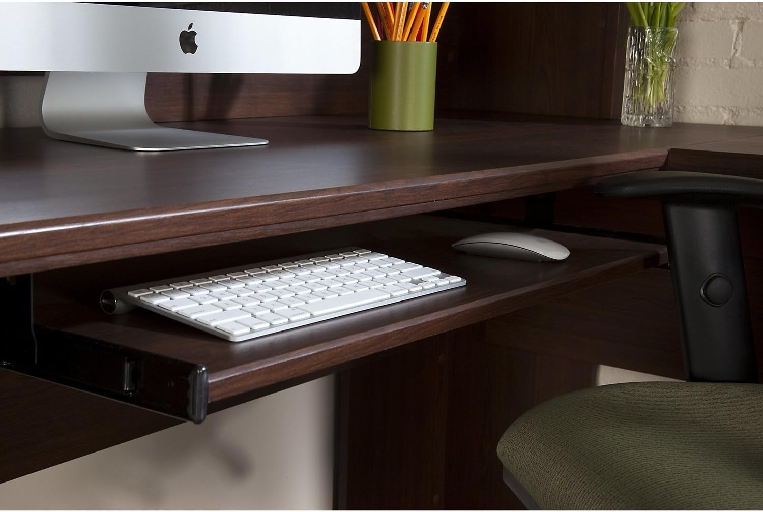 Close-up of the pull-out keyboard tray with a keyboard and mouse
