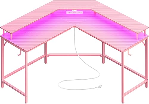 Huuger - Escritorio para juegos en forma de L con tomas de corriente y luces LED, escritorio para computadora con estantes para monitor, superficie