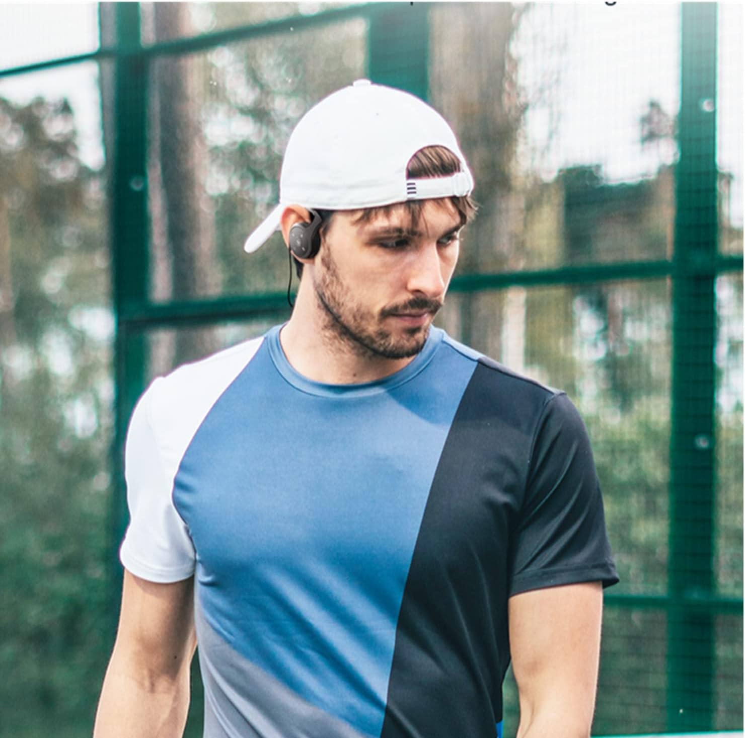 A person wearing the XUJAIOLQP Behind The Head Headphones during an outdoor activity, demonstrating their secure fit.