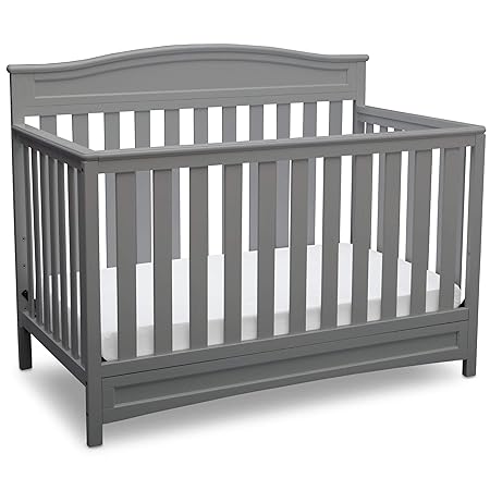 mini crib next to bed