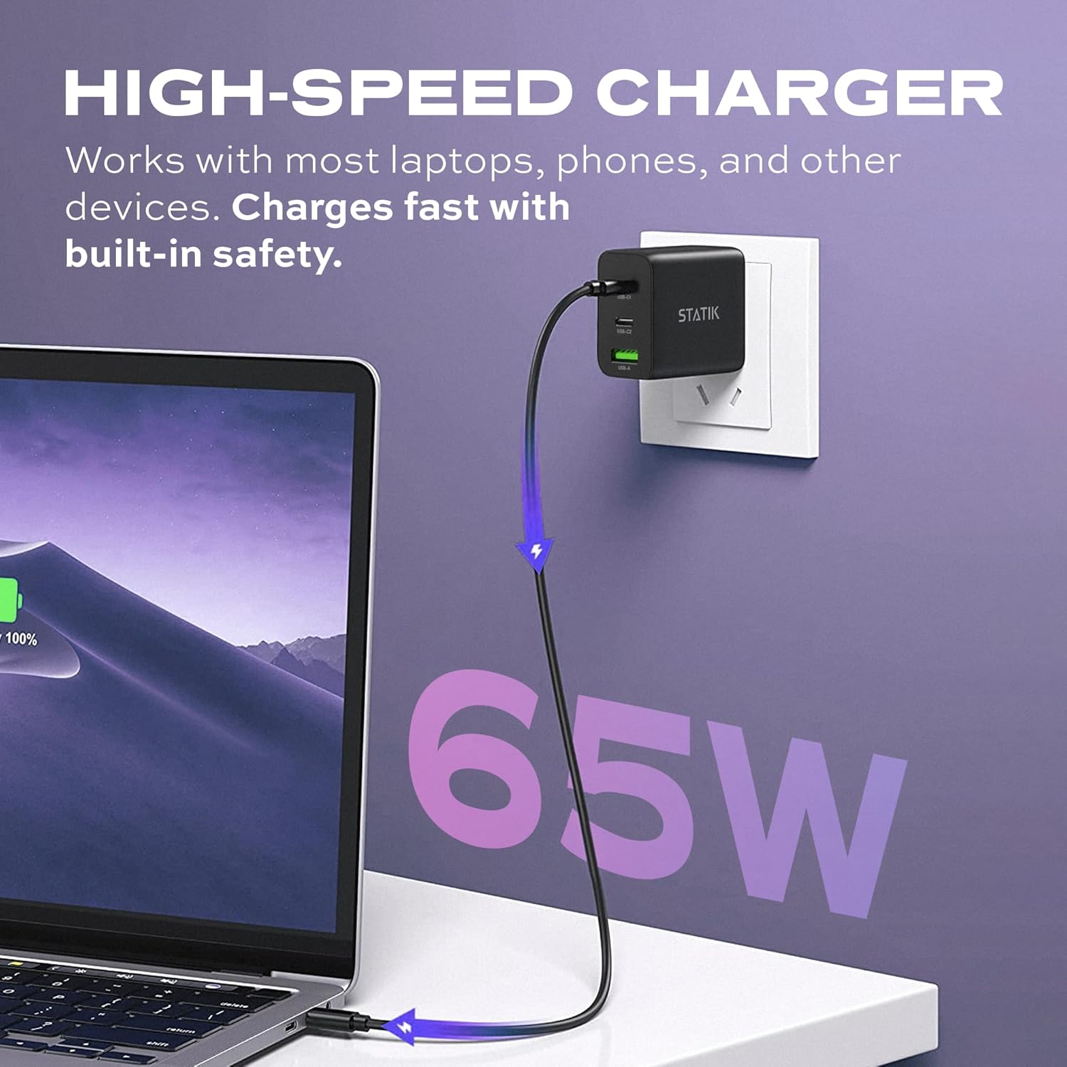 Statik 65W GaN Charger plugged into a wall outlet, charging a laptop