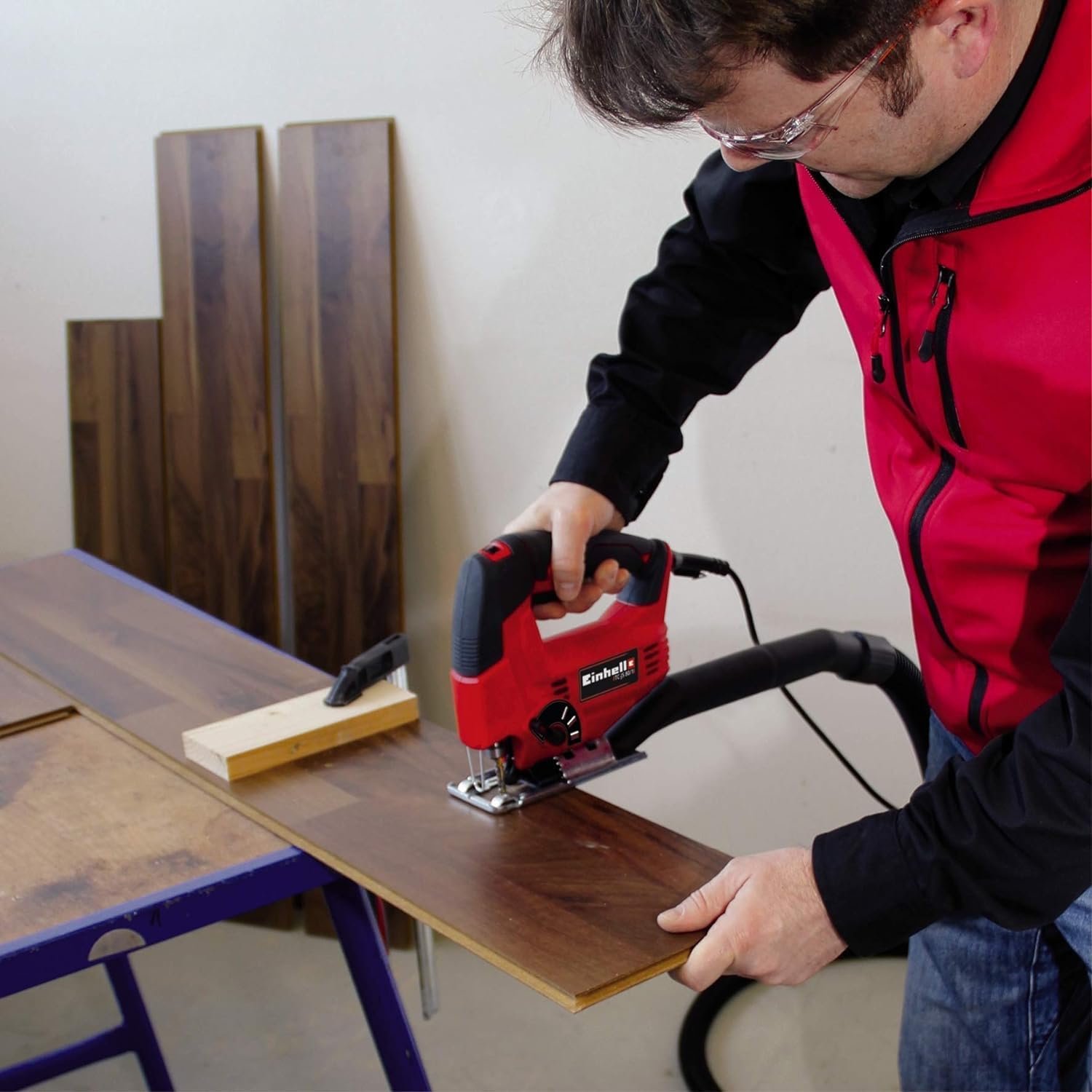 Man operating Einhell jigsaw to cut wood