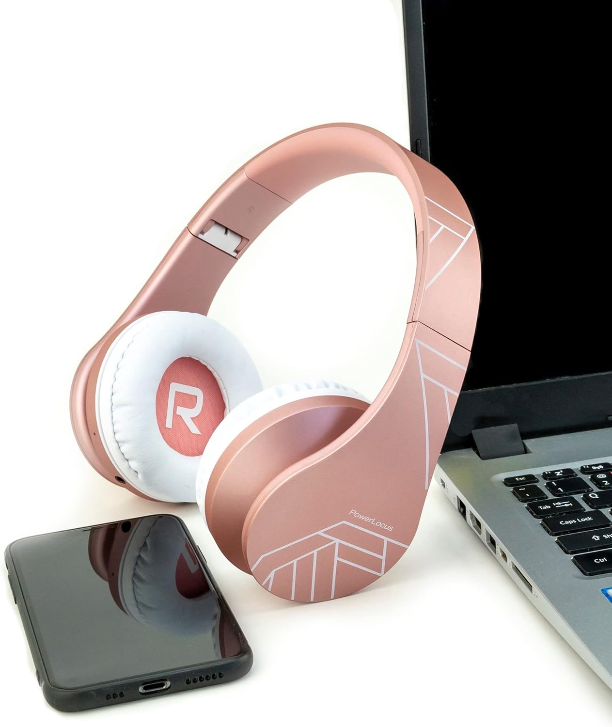 PowerLocus P2 headphones next to a laptop and smartphone, demonstrating universal compatibility.