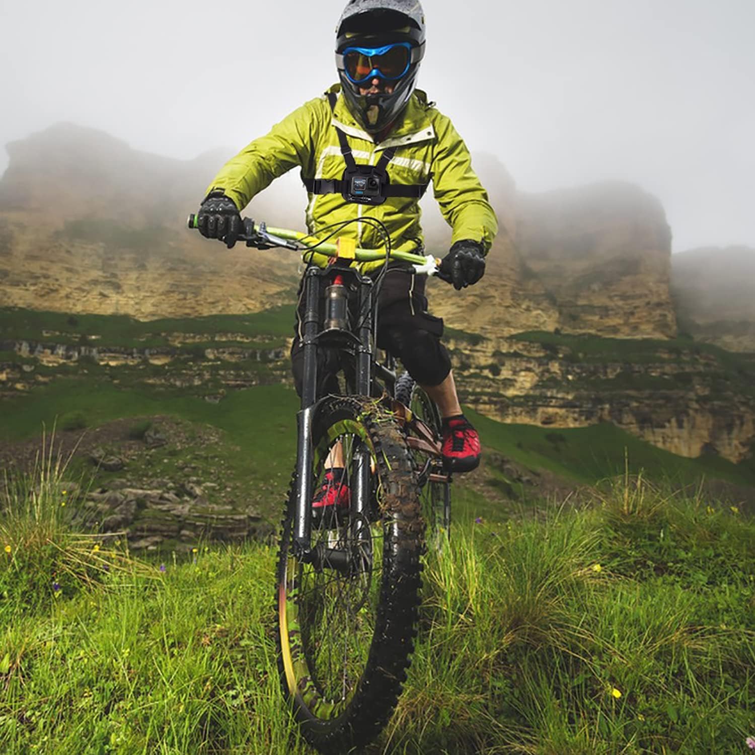 Person mountain biking on a trail while wearing the Suptig Chest Mount with an action camera.
