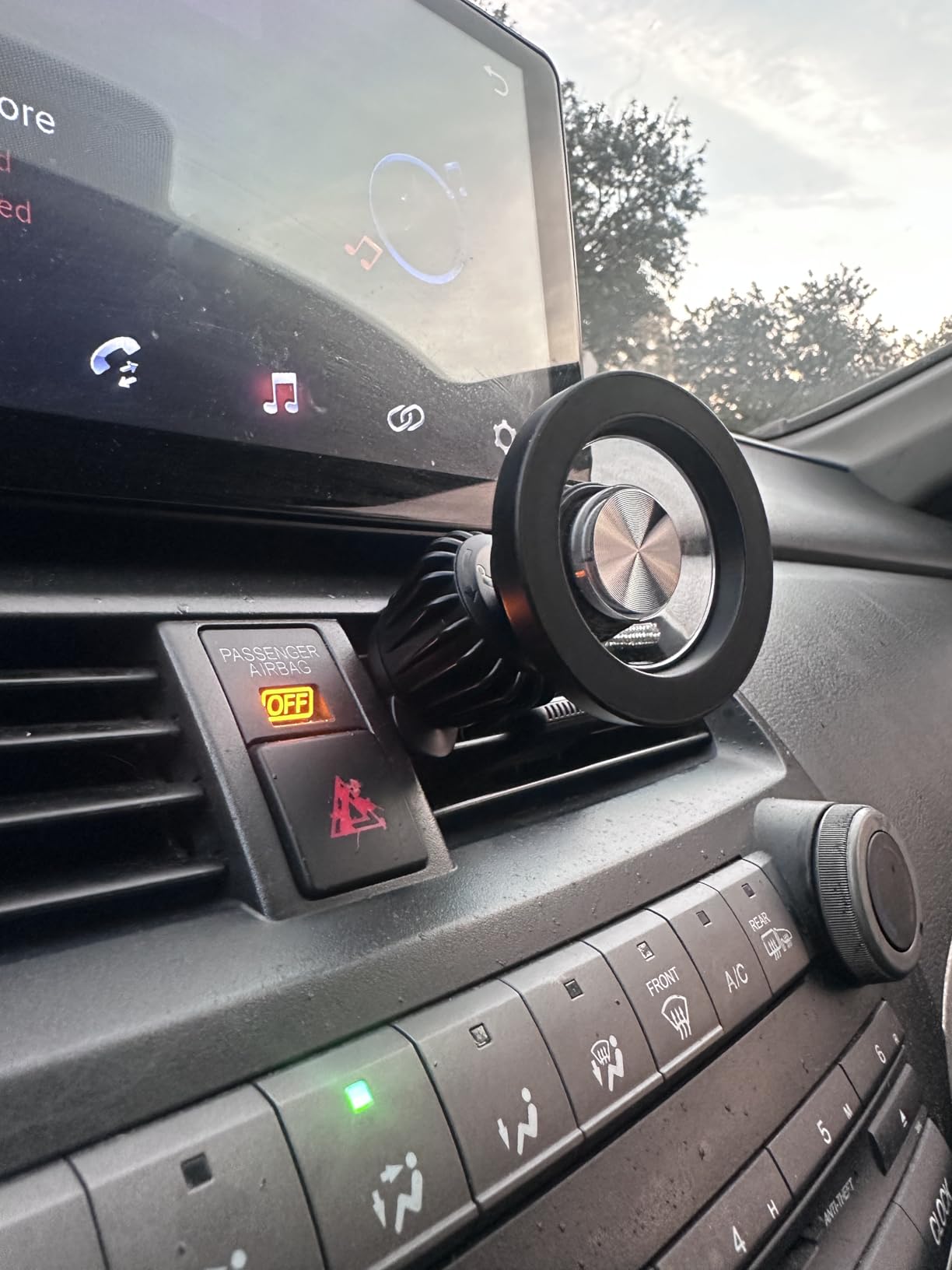 MagSafe car mount attached to car vent with metal hook