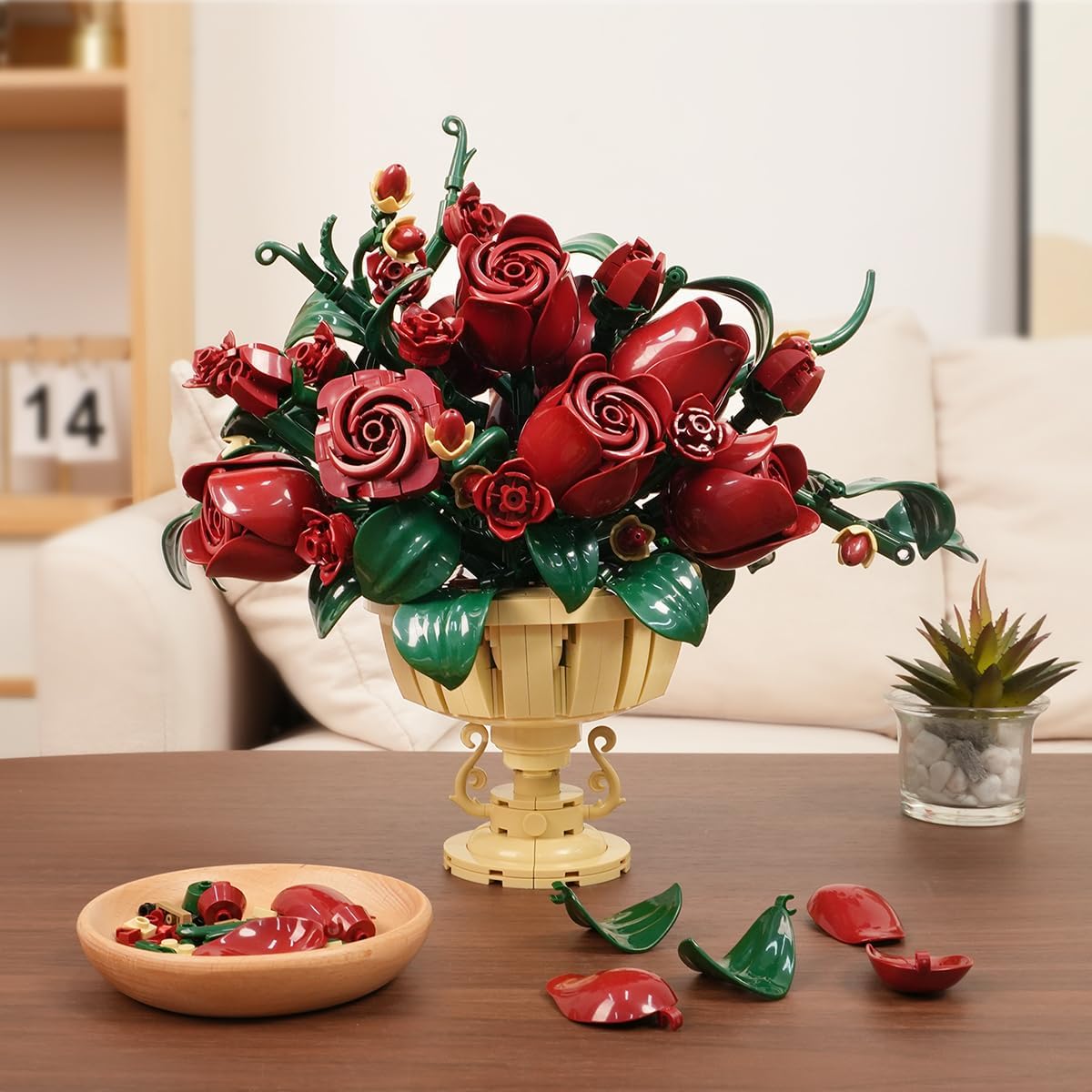 Assembled rose flower building set displayed on a wooden table in a living room setting.