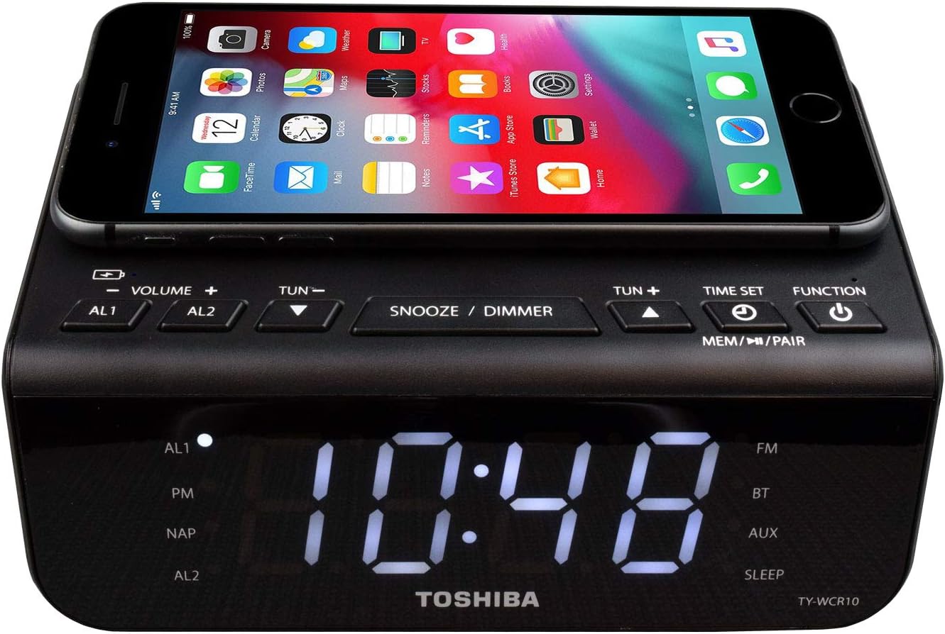 Top-down view of the Toshiba TY-WCR10 showing the control buttons and the Qi wireless charging pad with a smartphone placed on it.