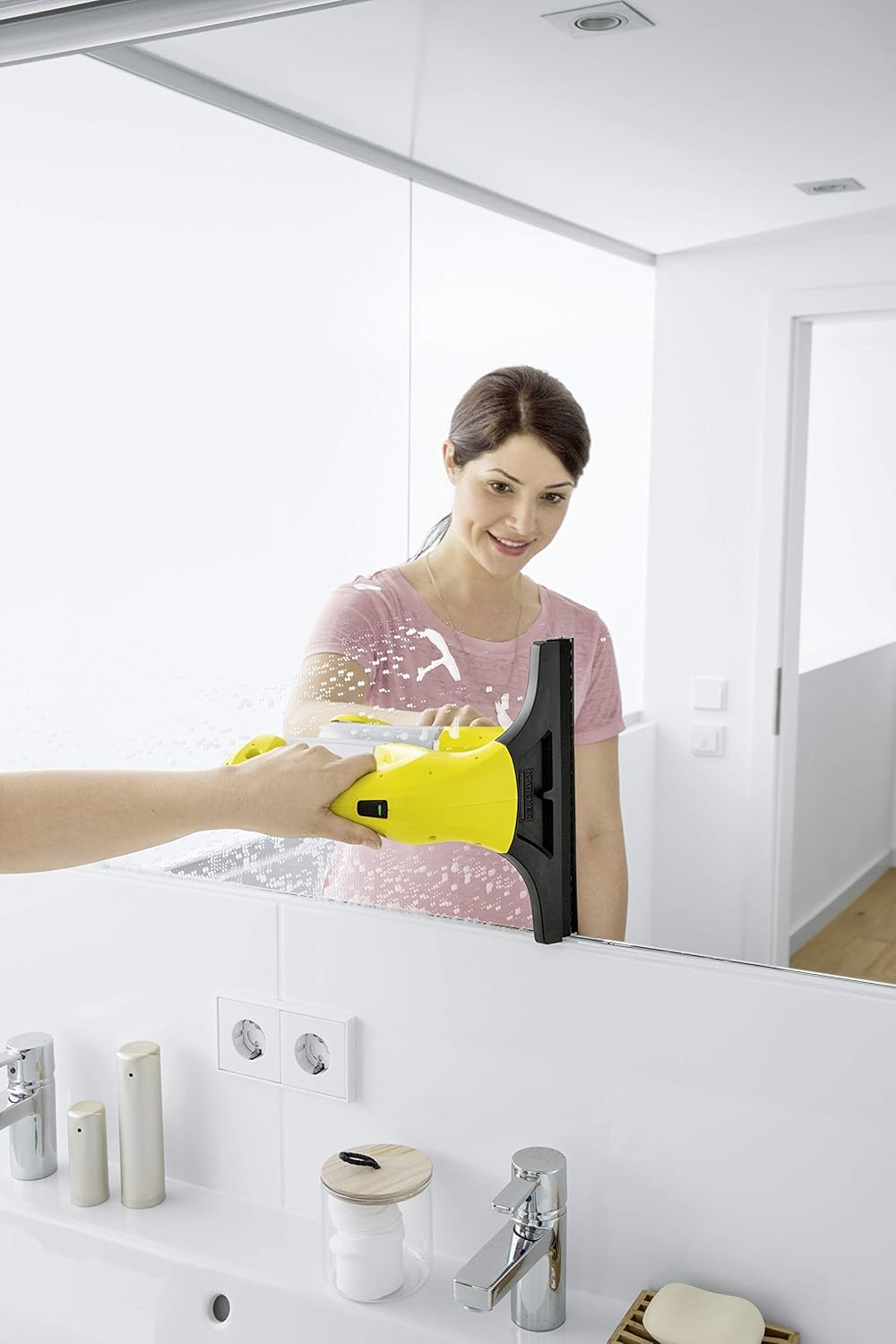 Woman cleaning a mirror with Karcher WV 1 Plus