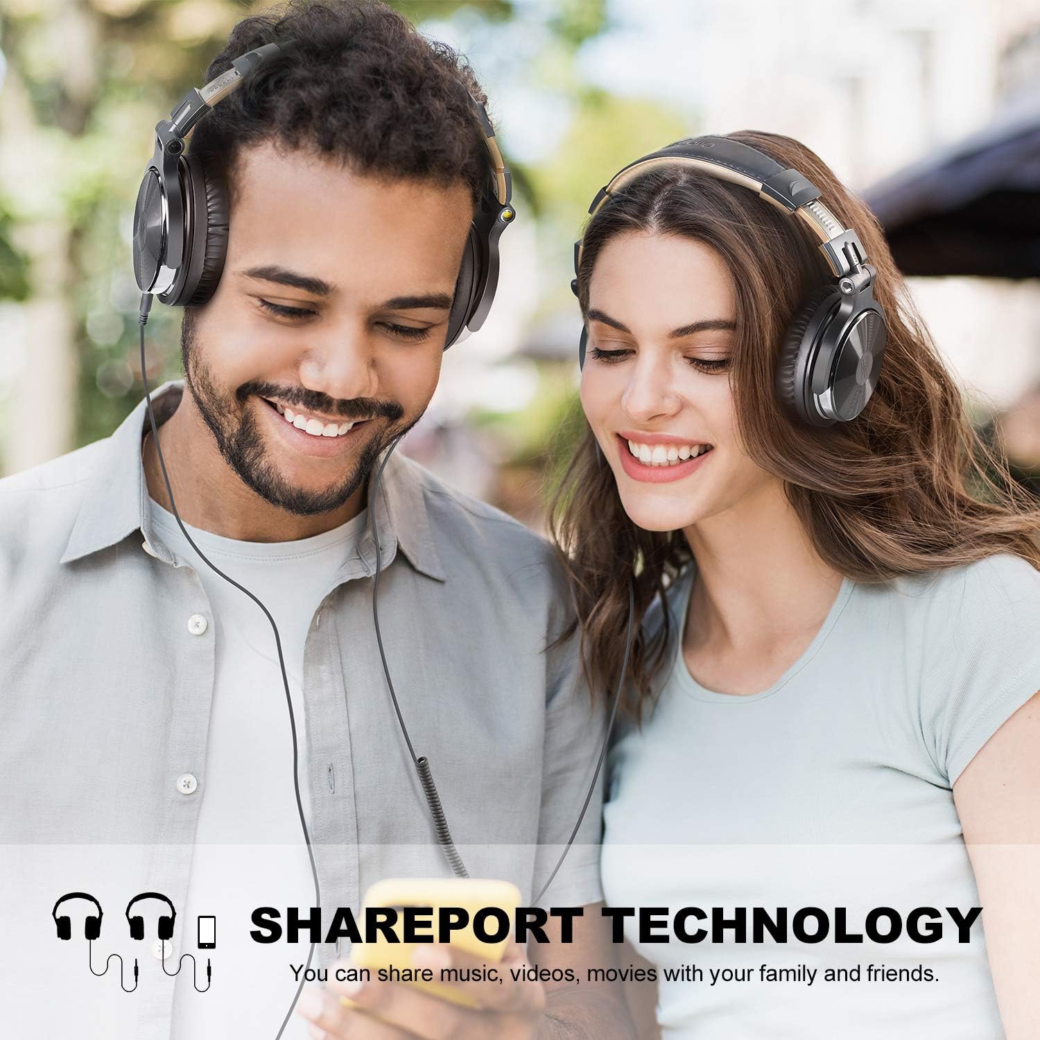 Two people sharing music using OneOdio headphones with SharePort technology, where one headphone is plugged into another.
