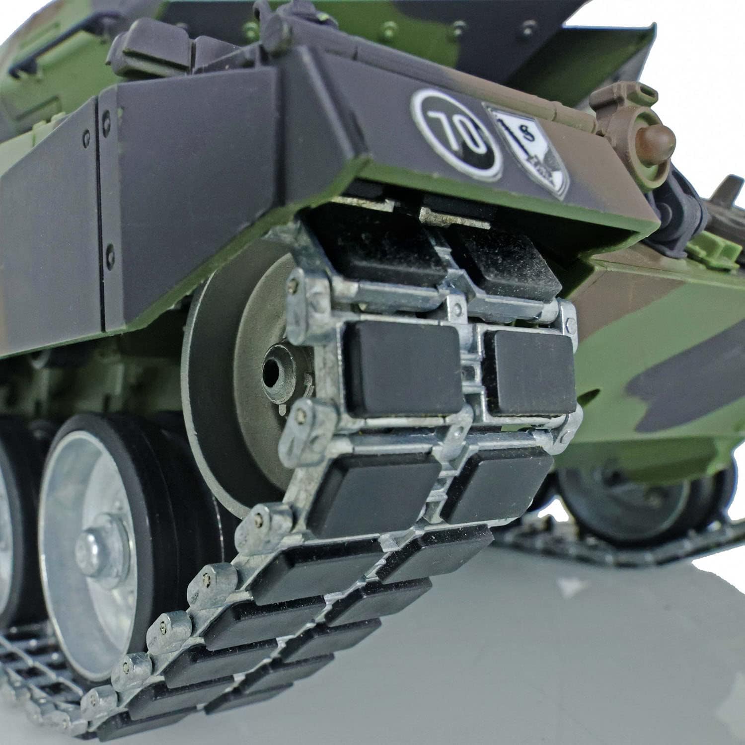 Close-up view of the tank's metal tracks with rubber pads.