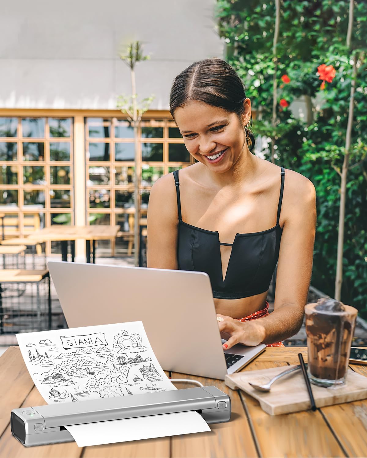 Man working at a desk with the Phomemo M08F printer, showing mobile office printing.