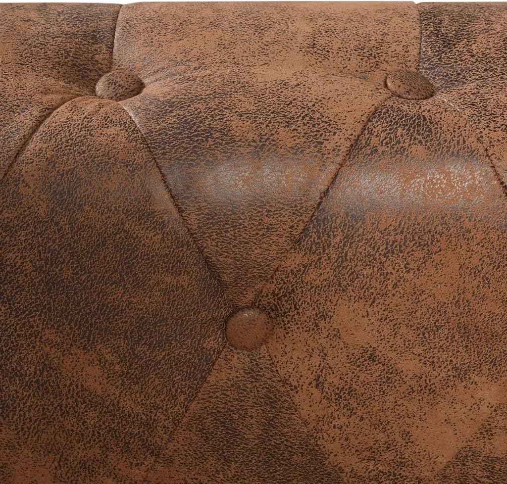 Brown faux leather Chesterfield corner sofa in a spacious living room with a coffee table.