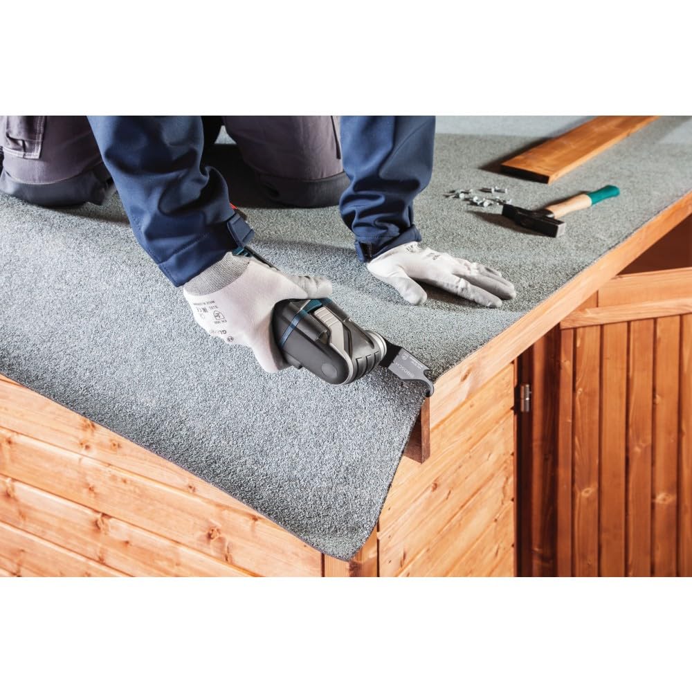 Oscillating multi-tool with Starlock blade being changed