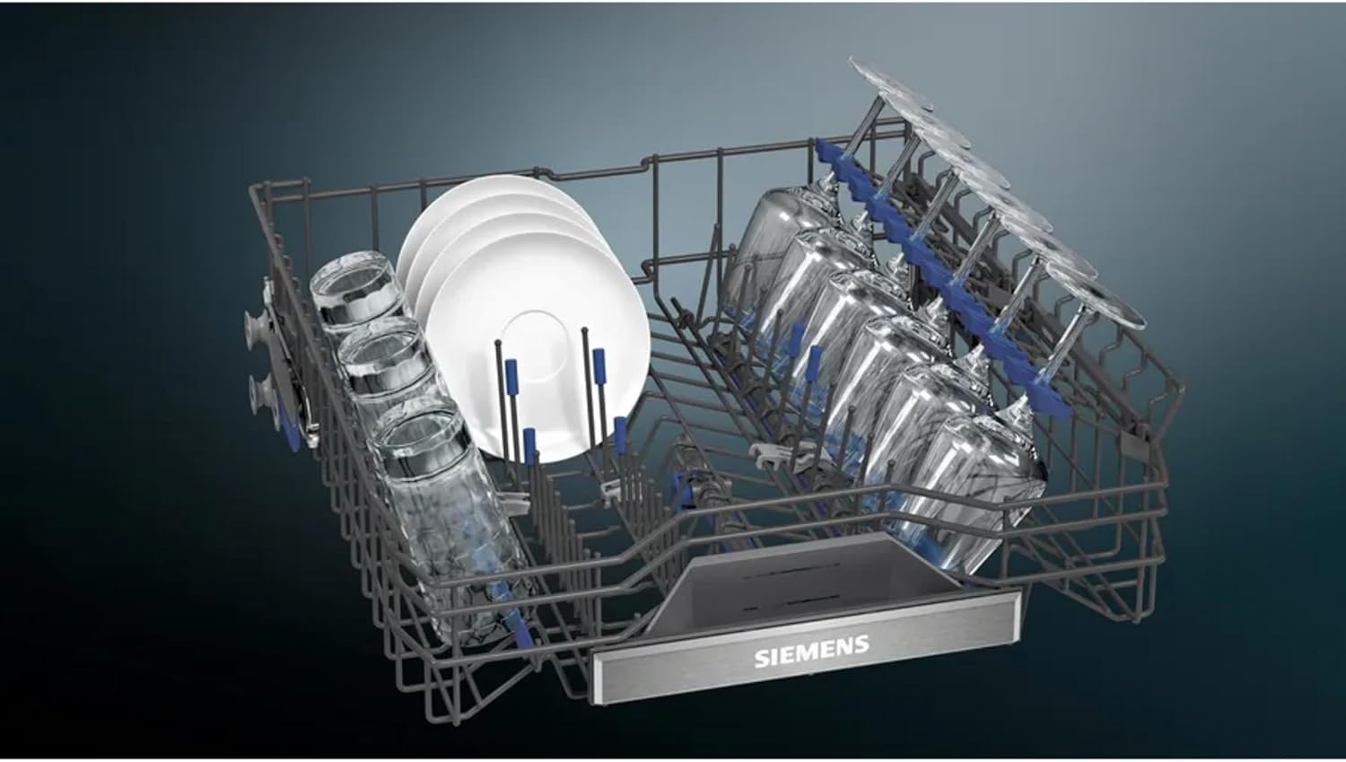 Lower dishwasher basket loaded with plates and glasses, demonstrating the flexible tines.
