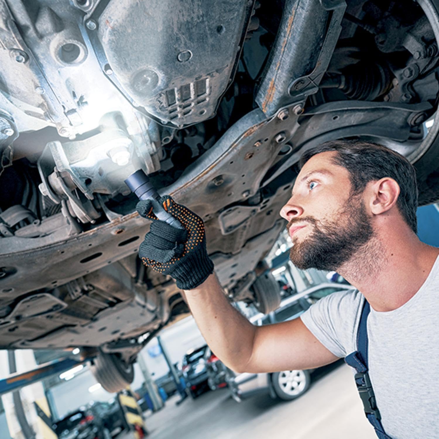 Man inspecting car with Xanlite TO250S flashlight
