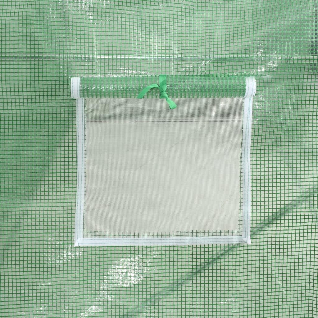 Close-up of a greenhouse ventilation window with mesh screen