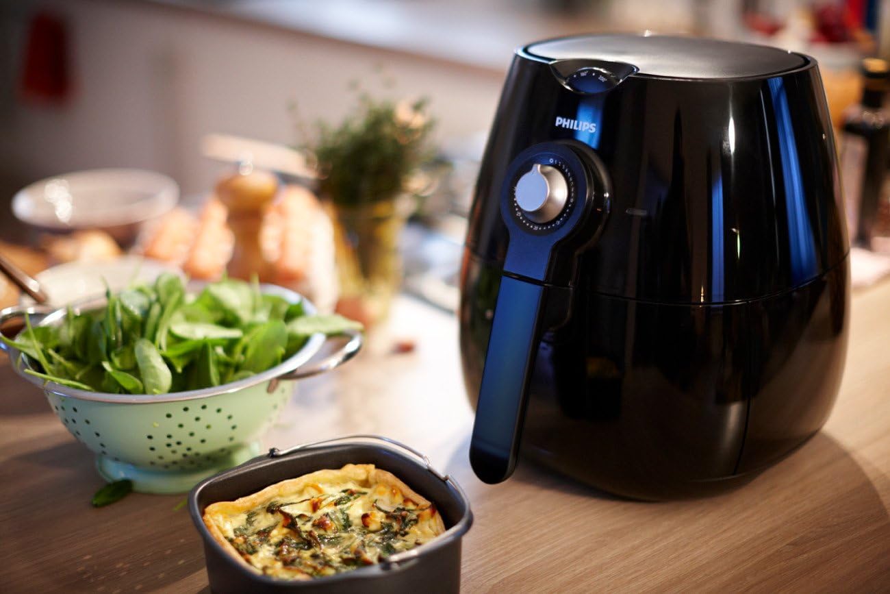 Philips Airfryer with a small quiche baked in the HD9925/00 baking pan, placed on a kitchen counter.