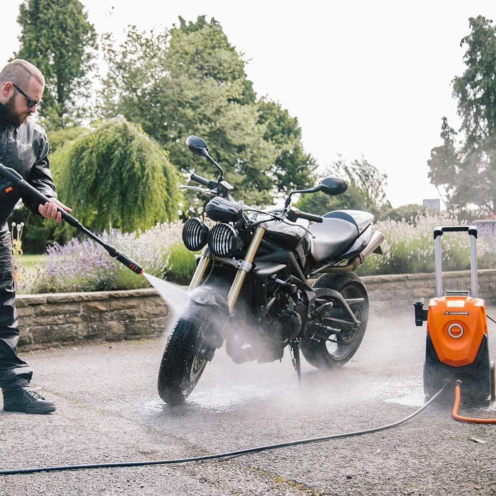 Person using pressure washer to clean a motorcycle