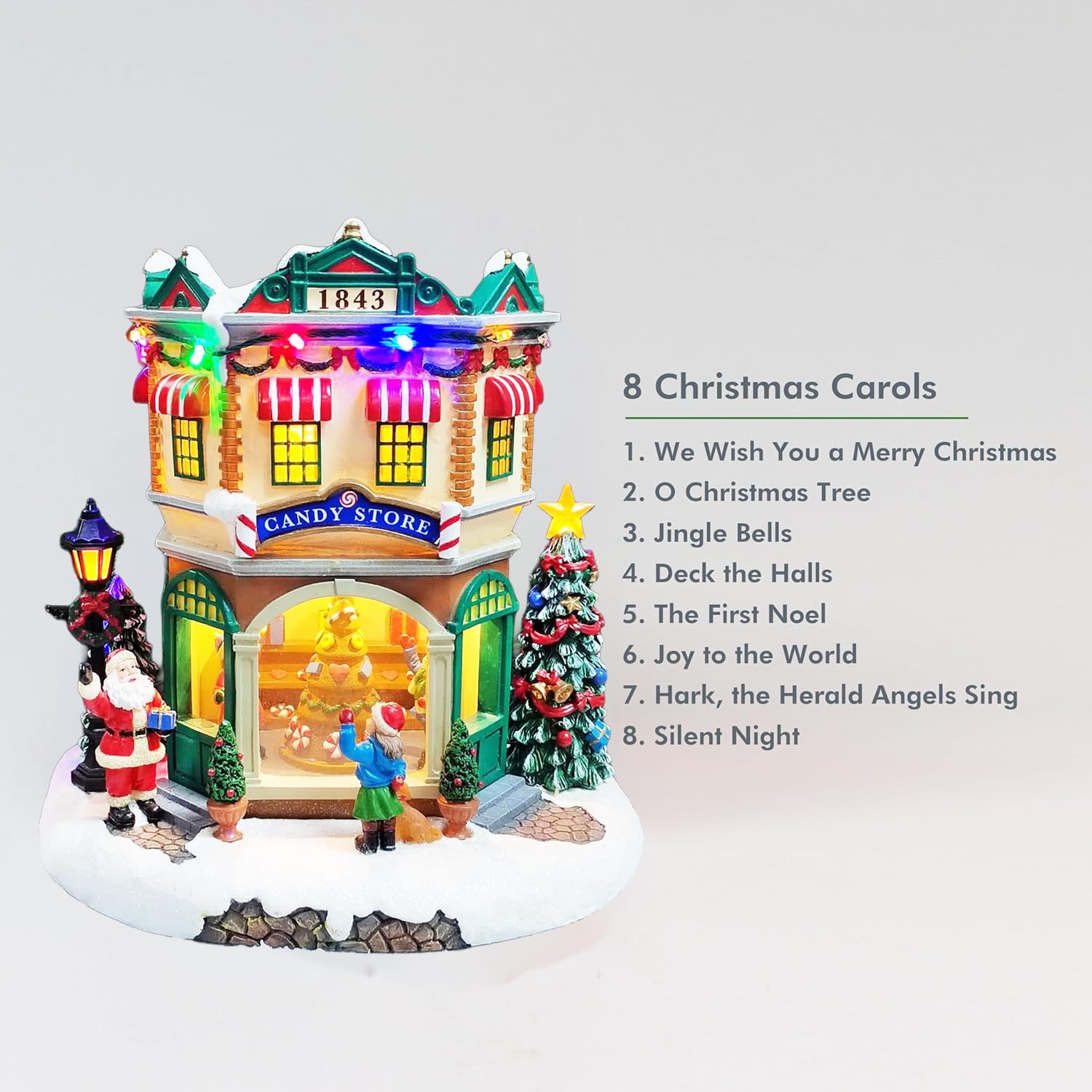 MOMENTS IN TIME Village de Noël LED et magasin de bonbons musicaux en polyrésine 26 cm de hauteur