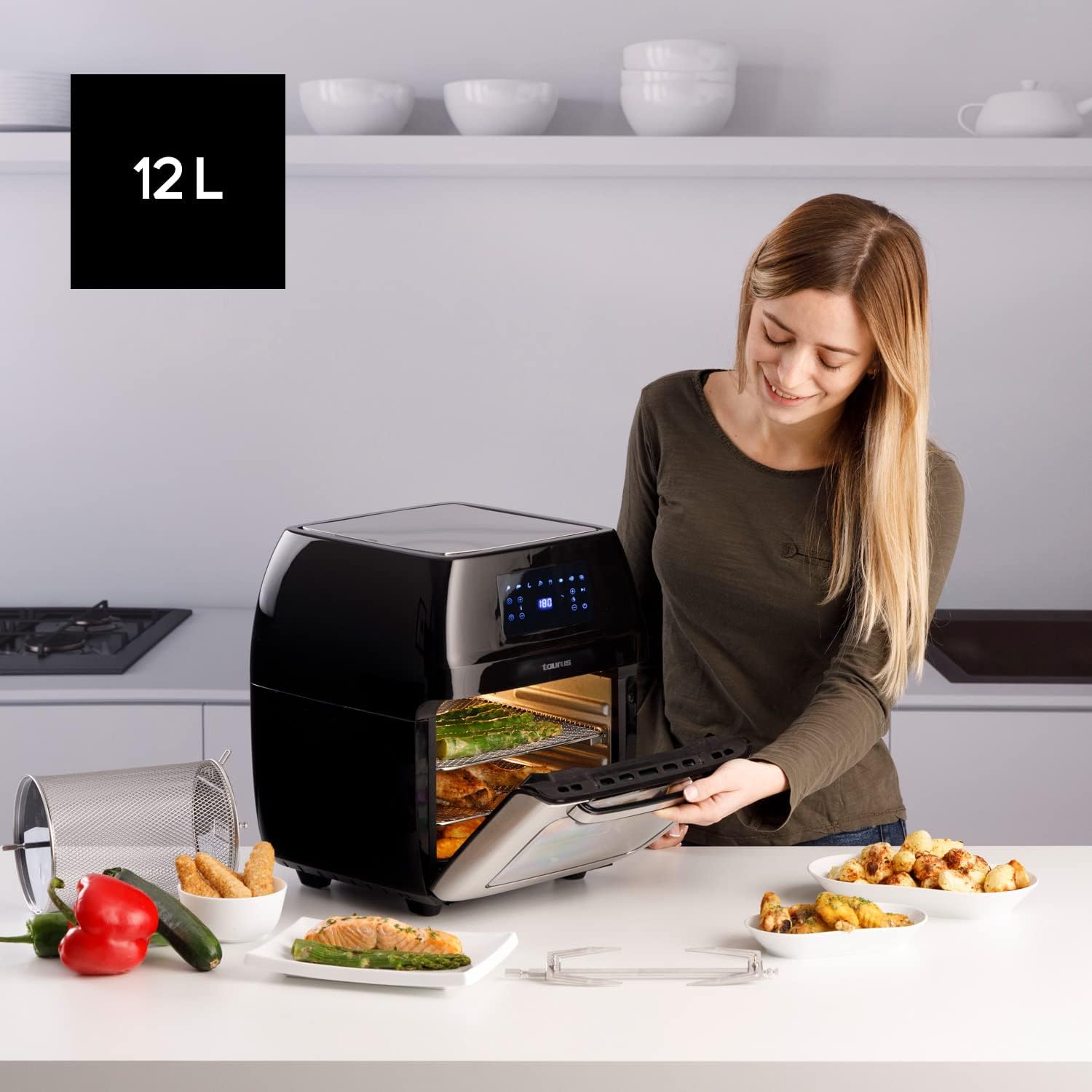 Woman interacting with the Taurus Air Fry Digital Grill in a kitchen setting, showing its 12L capacity.