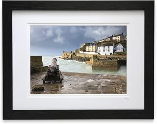 Mounted or framed photograph by Andrew Ray featuring a canon and storm clouds at Porthleven in Cornwall.