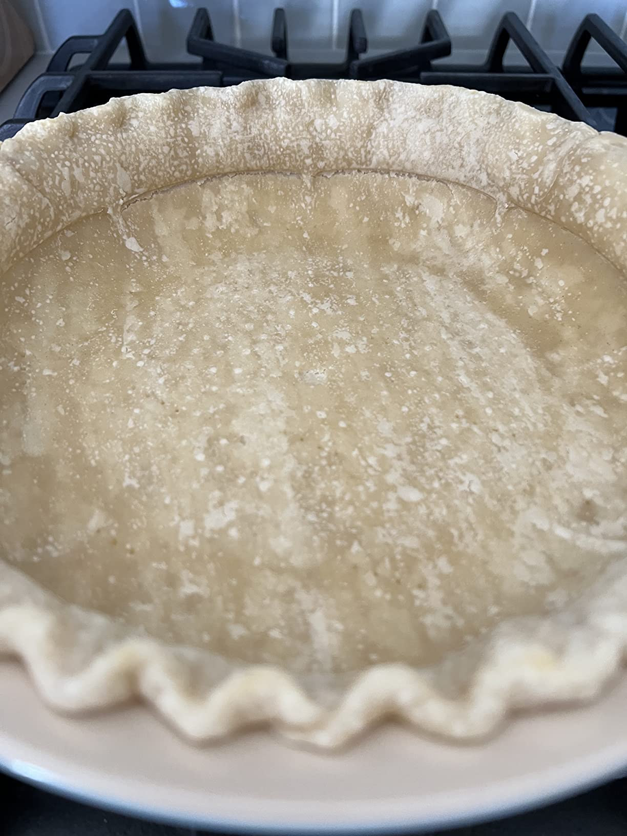 Slices pie crust around edges.